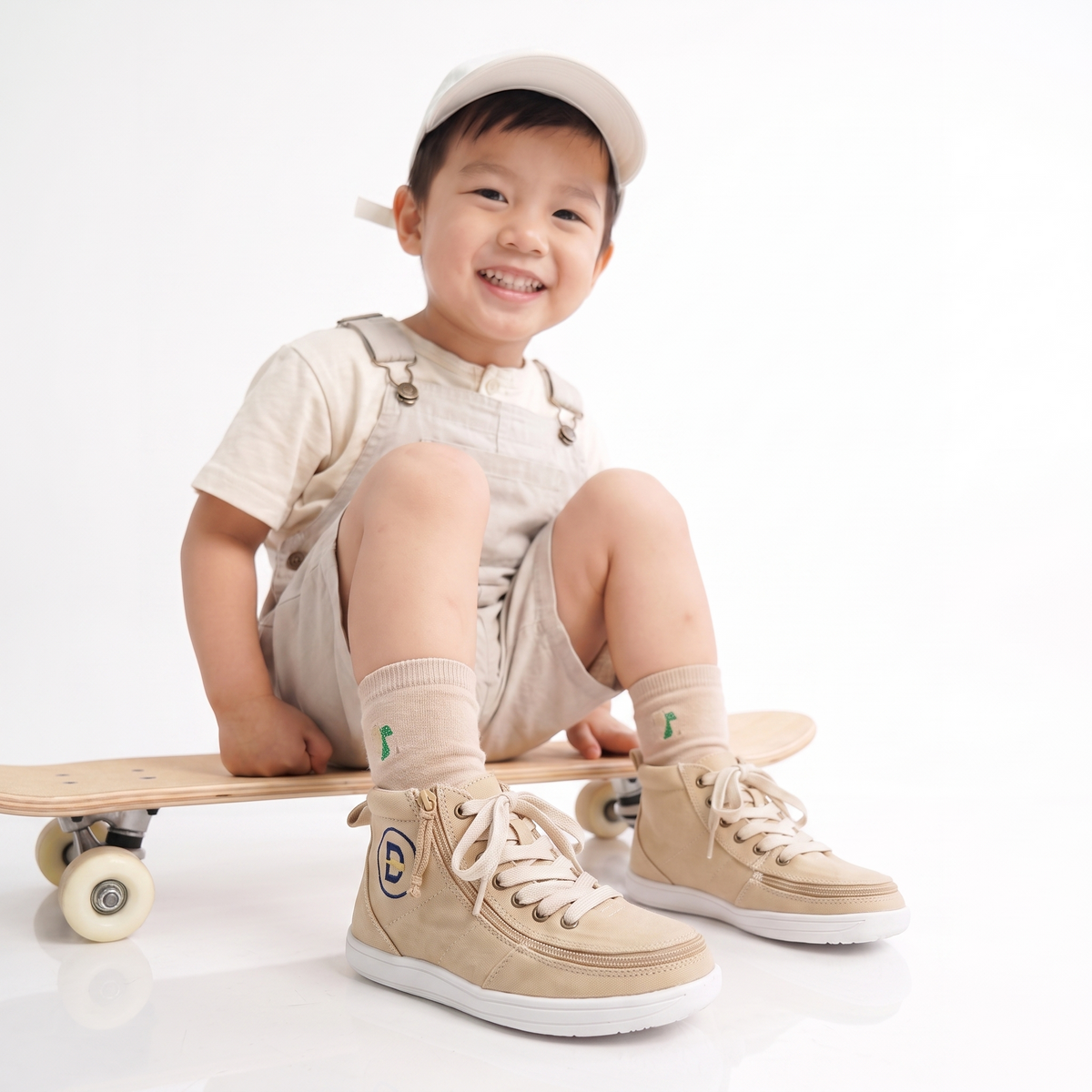 A parent struggling to put shoes on a toddler
